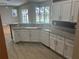 Spacious kitchen features granite countertops, stainless steel appliances, and white cabinets at 402 Knight Dr, Tarpon Springs, FL 34688