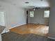 Bright living room with hardwood floors and sliding doors to the pool area at 402 Knight Dr, Tarpon Springs, FL 34688