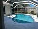 Screened-in pool area with a kidney-shaped pool at 402 Knight Dr, Tarpon Springs, FL 34688