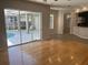 Spacious living room with hardwood floors and access to the pool area at 402 Knight Dr, Tarpon Springs, FL 34688