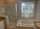 Bathroom with soaking tub, shower, and updated vanity at 402 Knight Dr, Tarpon Springs, FL 34688