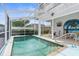 Inviting screened-in pool with a tropical mural at 6412 Yvette Dr, Hudson, FL 34667