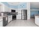 Bright kitchen features stainless steel appliances and light cabinets at 6412 Yvette Dr, Hudson, FL 34667