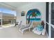 Peaceful patio with beach mural, lounge chairs, and seating area at 6412 Yvette Dr, Hudson, FL 34667