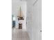 Hallway with decorative sailboat and storage cabinet at 6412 Yvette Dr, Hudson, FL 34667