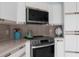 Modern kitchen with stainless steel appliances and ample counter space at 6412 Yvette Dr, Hudson, FL 34667