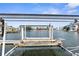 Private boat lift with calm waterway views in the background at 6412 Yvette Dr, Hudson, FL 34667