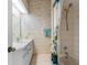 Bathroom with shower/tub combo and floral wallpaper at 6412 Yvette Dr, Hudson, FL 34667