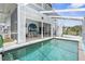 Inviting screened-in pool with a beach mural and patio area at 6412 Yvette Dr, Hudson, FL 34667
