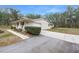 Ranch-style home with attached garage and manicured landscaping at 4148 Batten Rd, Brooksville, FL 34602