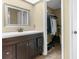 Bathroom with dark brown vanity and walk-in closet at 4148 Batten Rd, Brooksville, FL 34602