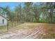 Large backyard with a fenced area and mature trees at 4148 Batten Rd, Brooksville, FL 34602