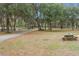 Wooden picnic table nestled amongst the trees near fence at 4148 Batten Rd, Brooksville, FL 34602