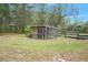 Wooden chicken coop with attached run in a grassy area at 4148 Batten Rd, Brooksville, FL 34602