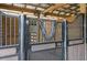 Individual stall with metal gate and wooden accents at 4148 Batten Rd, Brooksville, FL 34602