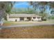 Ranch-style home with landscaping and a long driveway at 4148 Batten Rd, Brooksville, FL 34602