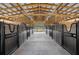 Spacious barn with multiple horse stalls and a wide aisle at 4148 Batten Rd, Brooksville, FL 34602