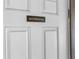 Simple white bathroom door with a dark brown sign at 4148 Batten Rd, Brooksville, FL 34602