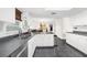 Modern kitchen with white cabinets, stainless steel appliances, and dark countertops at 4148 Batten Rd, Brooksville, FL 34602