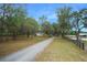 Long driveway leading to a ranch house, lined with trees at 4148 Batten Rd, Brooksville, FL 34602
