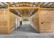 Spacious barn with multiple stalls and a wide center aisle at 4148 Batten Rd, Brooksville, FL 34602
