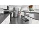 Modern kitchen with white cabinets, stainless steel appliances, and dark countertops at 4148 Batten Rd, Brooksville, FL 34602