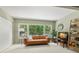 Relaxing living room with a leather couch, built in shelving, and large window at 2260 Costa Rican Dr # 24, Clearwater, FL 33763