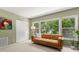 Bright bedroom with a leather couch, large window and built-in shelving at 2260 Costa Rican Dr # 24, Clearwater, FL 33763