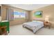 Well-lit bedroom with double window and green dresser at 2260 Costa Rican Dr # 24, Clearwater, FL 33763
