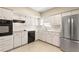 Updated kitchen with stainless steel refrigerator and white cabinets at 2260 Costa Rican Dr # 24, Clearwater, FL 33763