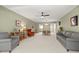 Living room with grey and orange armchairs, and a view into the dining area at 2260 Costa Rican Dr # 24, Clearwater, FL 33763