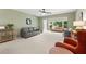 Living room with gray and orange armchairs, a couch, and ample natural light at 2260 Costa Rican Dr # 24, Clearwater, FL 33763