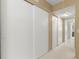 Long hallway with double sliding doors and carpet flooring at 2260 Costa Rican Dr # 24, Clearwater, FL 33763