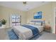 Main bedroom featuring a sliding glass door to the patio, a blue accent rug and a decorative wall painting at 6419 Cardinal Crest Dr, New Port Richey, FL 34655