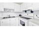 White kitchen with stainless steel appliances and ample counter space at 11937 Bayonet Ln, New Port Richey, FL 34654
