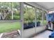 Relaxing screened porch overlooking a lush green backyard at 11937 Bayonet Ln, New Port Richey, FL 34654