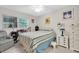 Comfortable bedroom with striped bedding, dresser, and ceiling fan at 11937 Bayonet Ln, New Port Richey, FL 34654