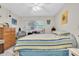 Relaxing bedroom with a striped bedspread and plenty of closet space at 11937 Bayonet Ln, New Port Richey, FL 34654