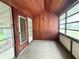 Relaxing screened porch with wood paneling and wood floors at 807 E Norfolk St, Tampa, FL 33604