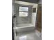 Bathroom with a soaking tub and marble tile at 6336 Wooden St, New Port Richey, FL 34653