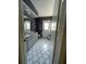 Clean bathroom with gray vanity, tile floor, and exterior access at 6336 Wooden St, New Port Richey, FL 34653