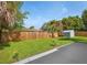 Large backyard with grassy lawn, shed, and wooden fence at 1037 Chelsea Ln, Holiday, FL 34691