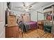 Bedroom with a ceiling fan, hardwood floors and large window for natural light at 1501 28Th N Ave, St Petersburg, FL 33704