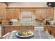 Well-lit kitchen featuring tile countertops, backsplash, wood cabinets, and stainless steel sink at 1501 28Th N Ave, St Petersburg, FL 33704