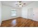 Well-lit bedroom with hardwood floors and a closet at 2348 Rolling View Dr, Spring Hill, FL 34606