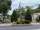 Community entrance with landscaped median and signage at 7278 Scotland Cir, Weeki Wachee, FL 34613