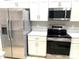 Modern kitchen with stainless steel appliances and white cabinets at 7278 Scotland Cir, Weeki Wachee, FL 34613