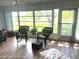 Bright sunroom with wicker furniture and view of backyard at 7278 Scotland Cir, Weeki Wachee, FL 34613