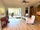 Living room with sliding doors to sunroom and wood shelving at 7278 Scotland Cir, Weeki Wachee, FL 34613