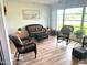 Sunroom with wicker furniture and wood flooring at 7278 Scotland Cir, Weeki Wachee, FL 34613